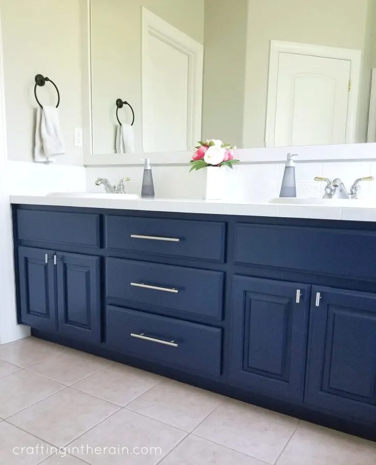 https://craftingintherain.com/wp-content/uploads/2019/09/navy-bathroom-cabinet-735x910.jpg.webp